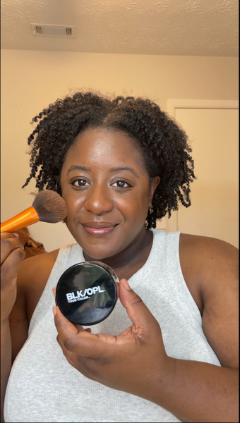 UGC creator holding makeup product 